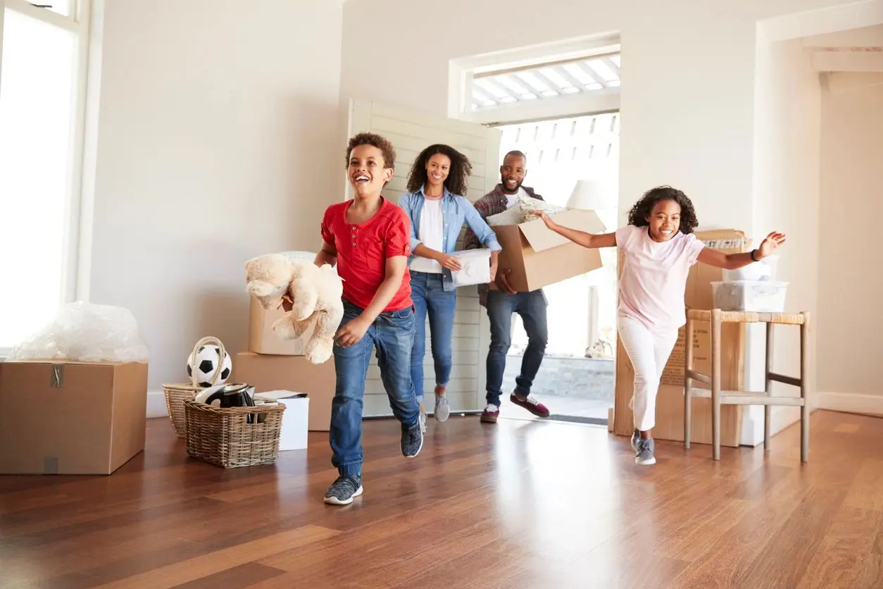 A group of people moving in a room.